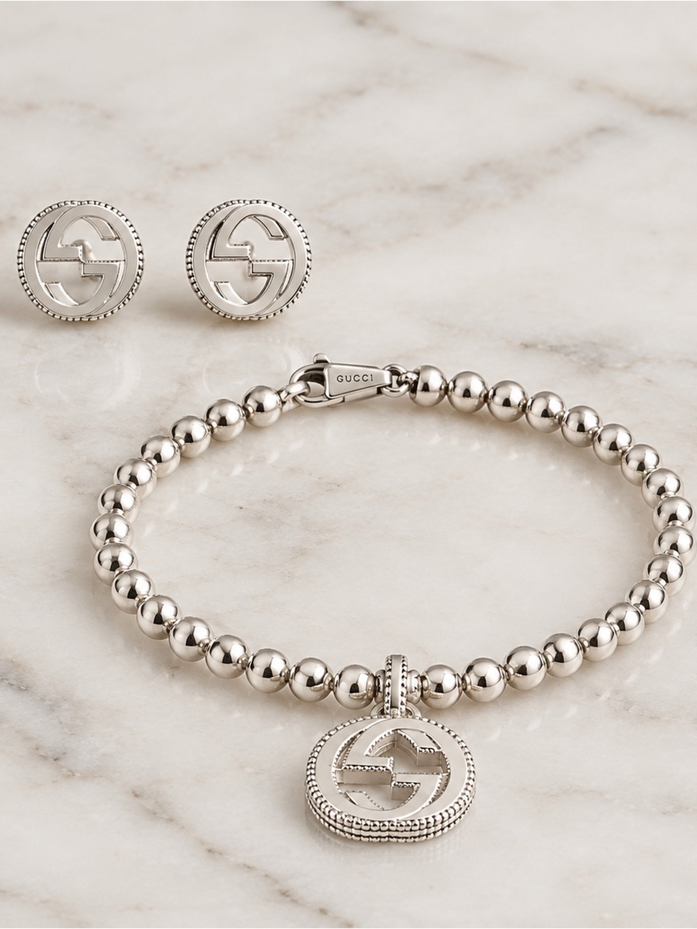 Gucci Silver Beaded Bracelet with Interlocking G Pendant and matching earrings.